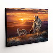 Coyotes on the prairie at sunset in 'The Setting Sun' canvas art print.
