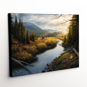 'When Time Slows' is a mountainous landscape canvas art print offering a serene vista of deep wilderness, a prominent moose, and the gentle flow of a stream at sunrise"